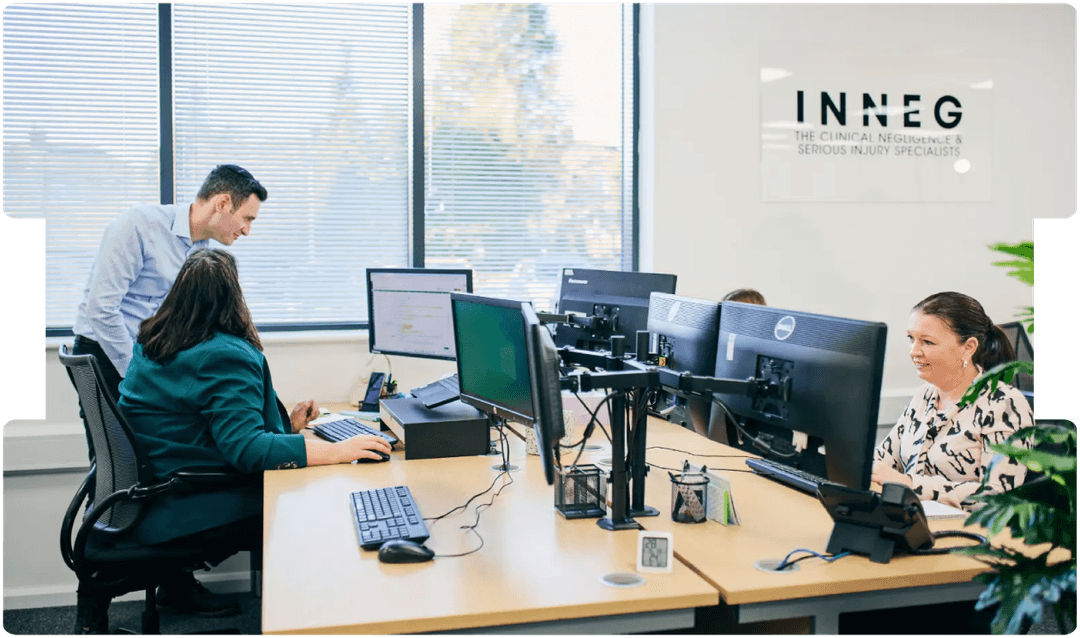 INNEG team collaborating in a modern office, showcasing professionalism and expertise in sourcing high-calibre medico-legal expert witnesses.